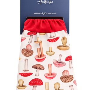 red gardening gloves hanging on display packaging with mushroom pattern