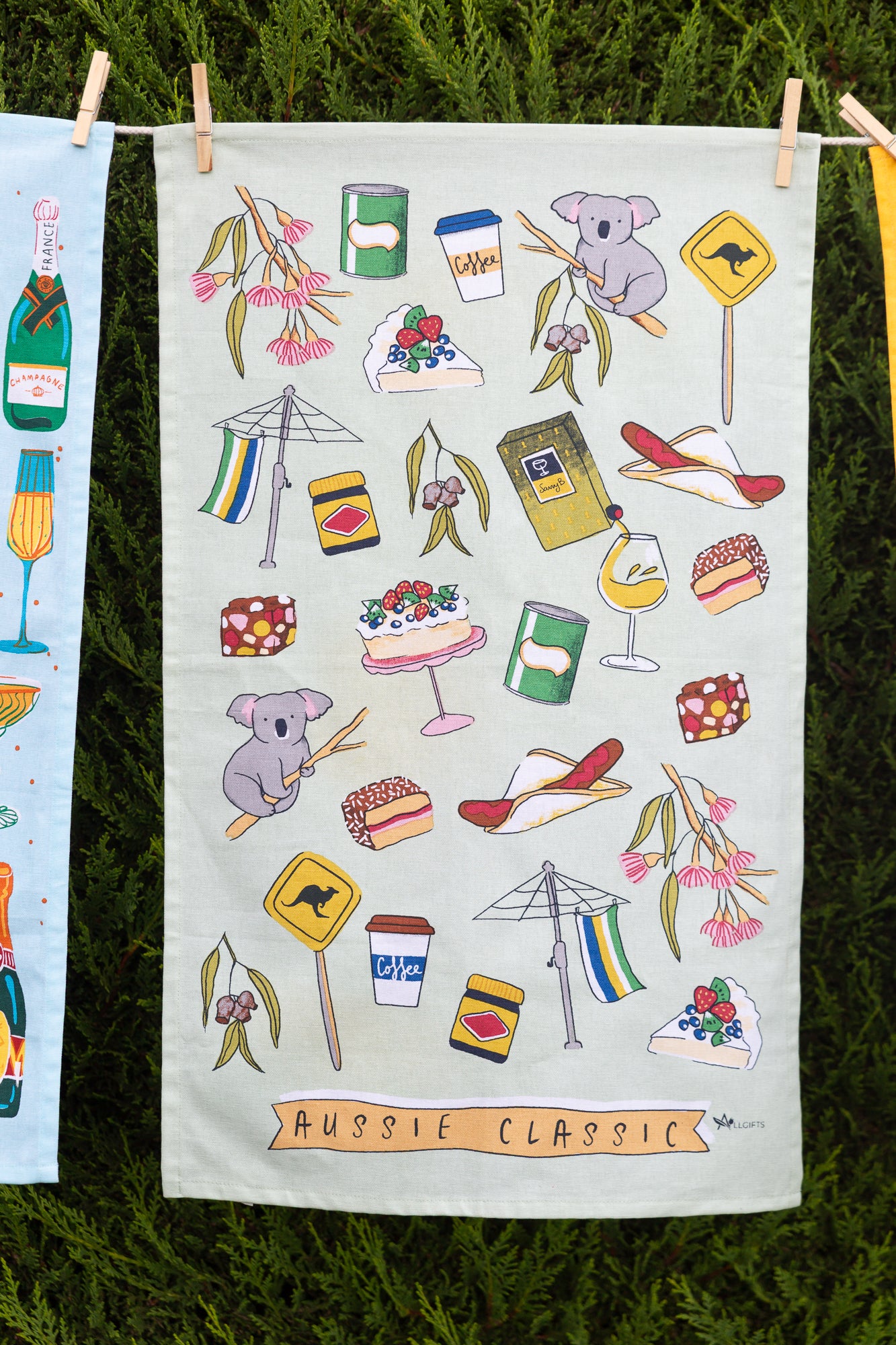 green towel with Australian iconic images on clothesline