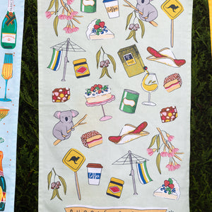 green towel with Australian iconic images on clothesline